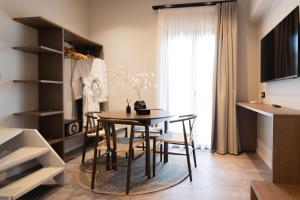 a dining room with a table and chairs at Ichos Boutique Apartments in Volissos +46 photos