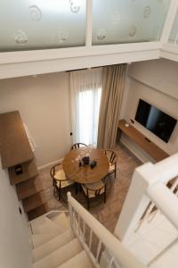 a living room with a table and a television at Ichos Boutique Apartments in Volissos