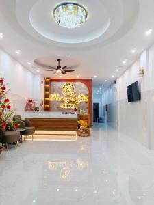 a hotel lobby with a hotel sign on the wall at Phương Ngân HOTEL in Hà Tiên