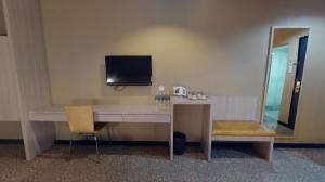 a desk with a computer and a chair in a room at Clover Hotel in Johor Bahru