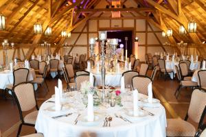 a room full of tables and chairs with white linens at Hotel Hirsch in Neu-Ulm
