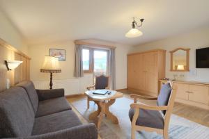 a living room with a couch and a table at Banders Landhaus in Imst