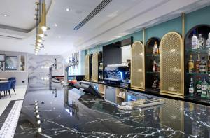 a bar with a counter with a lot of alcohol at Hilton London Croydon in Croydon