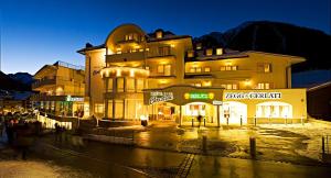 a large building in front of a street at night at Hotel Garni Christine in Ischgl