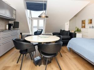 a room with a bed and a table and chairs at 2 person holiday home in Hejls in Hejls