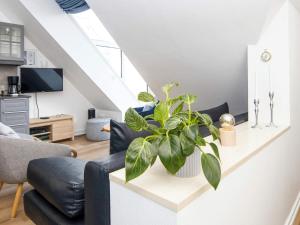 a living room with a couch and a plant at 2 person holiday home in Hejls in Hejls