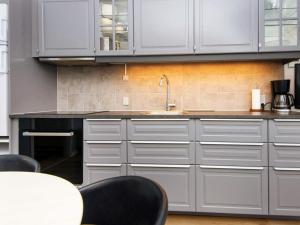 a kitchen with white cabinets and a sink at 2 person holiday home in Hejls in Hejls