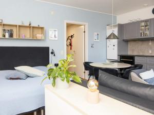a bedroom with a bed and a table and a kitchen at 2 person holiday home in Hejls in Hejls