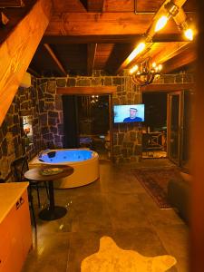 a large room with a tub and a tv at Lavinya Suit Bungalov in Rize