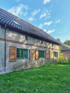 an old house with green grass in front of it at Wronki- mazurski spokój in Wronki