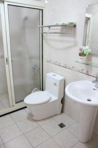 a bathroom with a toilet and a shower and a sink at Xinyue B&B in Fenglin +47 photos