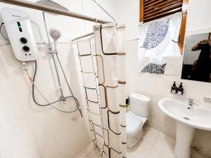 a bathroom with a shower and a toilet and a sink at PearlDrop Hills Kandy in Kandy +28 photos