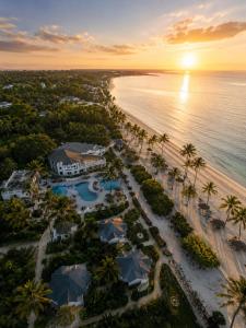an aerial view of the resort and the beach at sunset at Protels La Plage Resort in Bwejuu +69 photos