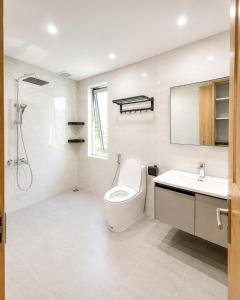 a bathroom with a toilet and a sink at Minh Khang Apartment in Danang +110 photos