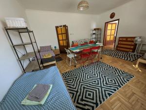 a living room with a table and a blue rug at B57 guesthouse in Budakalász