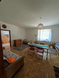 a living room with a table and a couch at B57 guesthouse in Budakalász