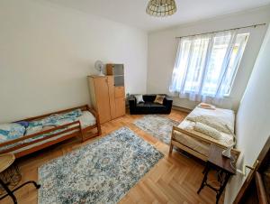 a living room with a bed and a couch at B57 guesthouse in Budakalász