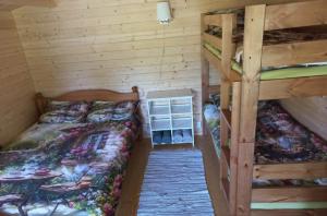 a bedroom with two bunk beds and a table at Muhu Garden Cabin in Suuremõisa