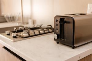 a toaster oven sitting on top of a kitchen counter at Wilkoppies Self Catering in Klerksdorp +68 photos