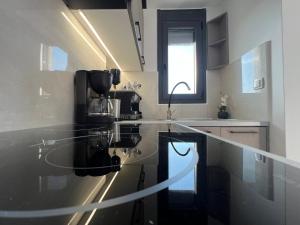 a kitchen with a glass counter top and a sink at Kohyli in Lefkada +169 photos