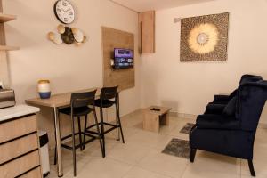 a living room with a table and a chair at Wilkoppies Self Catering in Klerksdorp