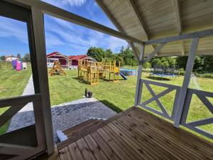 an open porch with a view of a playground at Domki Letniskowe U Żuni in Chłopy