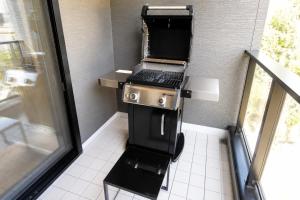 a kitchen with a stove with a laptop on it at Awaji Play Resort in Minamiawaji