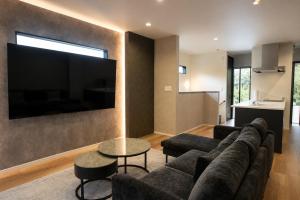 a living room with a couch and a flat screen tv at Awaji Play Resort in Minamiawaji