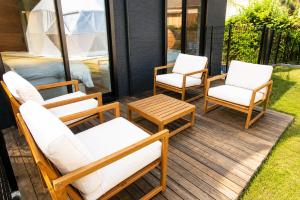 three chairs and a table on a deck at Awaji Play Resort in Minamiawaji