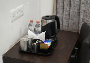 a coffee maker sitting on top of a table at Hotel Laasya Grand in Vijayawāda