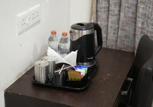a coffee maker sitting on top of a table at Hotel Laasya Grand in Vijayawāda +29 photos