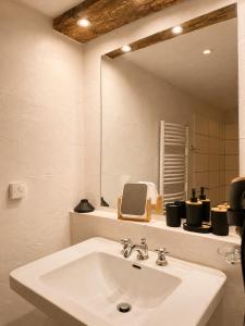 a bathroom with a white sink and a mirror at s'Morent in Zöblen +23 photos