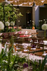 a group of tables and chairs in a room with flowers at Grand Mess Clermont-Ferrand in Clermont-Ferrand