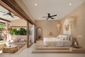 a bedroom with a large bed and a patio at Gili Boho Villas - Aesthetic Private Pool Villas in Gili Trawangan