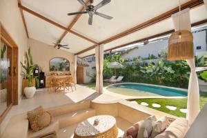 an open living room with a swimming pool and a house at Gili Boho Villas - Aesthetic Private Pool Villas in Gili Trawangan