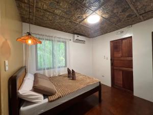 a room with a bed with a window and a couch at The LineUp Surf House Pacifico in San Isidro +25 photos