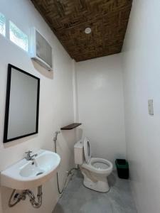 a bathroom with a toilet and a sink at The LineUp Surf House Pacifico in San Isidro