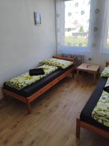a bedroom with two beds and a window at Družstevní dům Choustník in Choustník