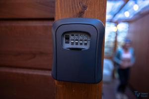 a cell phone is attached to a wooden pole at Trendy Villas Hostel in Vila Chã