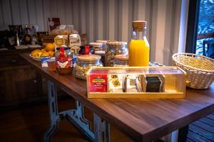 a table with food and a bottle of orange juice at Trendy Villas Hostel in Vila Chã
