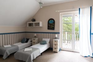 a bedroom with two beds and a window at Dwór Złotopolska Dolina Modlin Airport in Trębki +84 photos