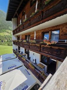 a building with tables and umbrellas in front of it at Hotel Buckelhof - See - Free Liftpass Summer in See