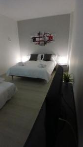 a bedroom with two white beds and a red light at MilanoValery3 in Milan
