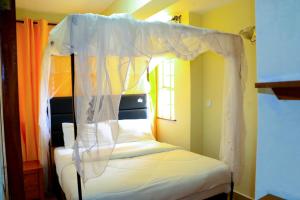 a bed with a canopy in a room at Dobajo Homes2 in Kisumu