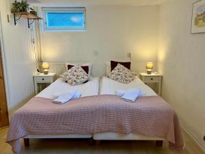 a bedroom with a bed with two pillows on it at Villa María - Charming 40 m2 lower level suite with private entrance in Simrishamn