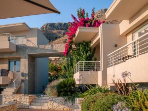 a house with flowers on the side of it at K Villas in Plataria