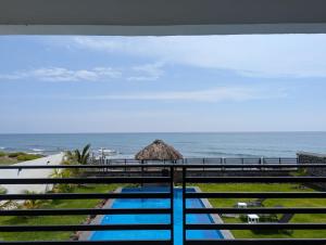 a view of the ocean from the balcony of a resort at Casa Playa Eugen beach house with pool in El Morro
