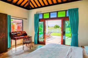 a bedroom with a bed and a desk and a window at Cathaya Private Pool Villa - Limasan Padi in Langkawi Intl +26 photos