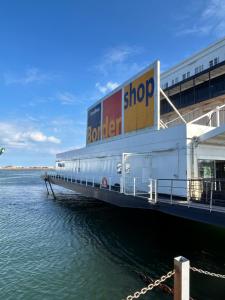 a building on a pier next to the water at Traveler Rooms in Rødby