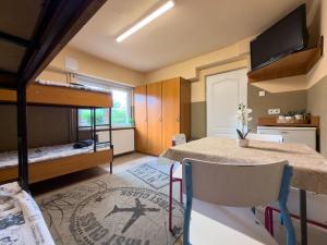 a room with bunk beds and a table and chairs at Hostel Relax in Warsaw